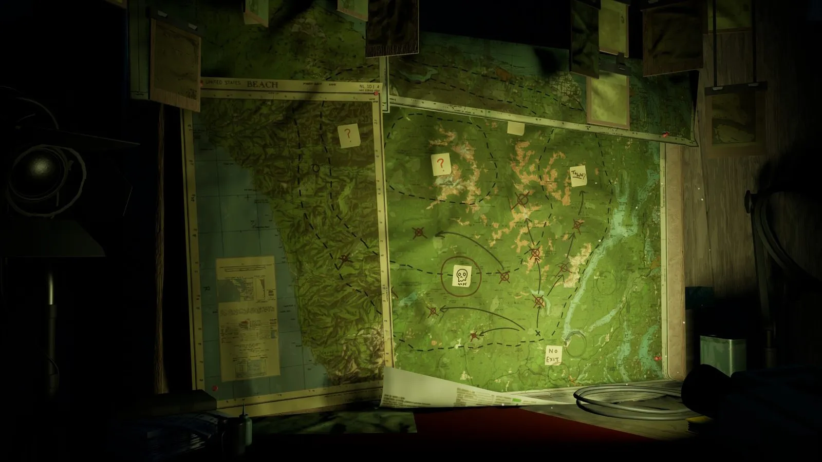 Un mapa de papel verdoso con marcas y chinchetas colgado en una pared, a la luz de una lámpara