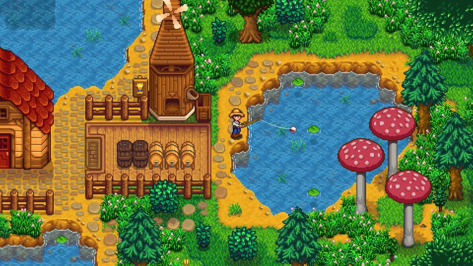Un granjero pesca junto a un estanque con tres hongos gigantes rojos, un molino de madera y pinos en Stardew Valley