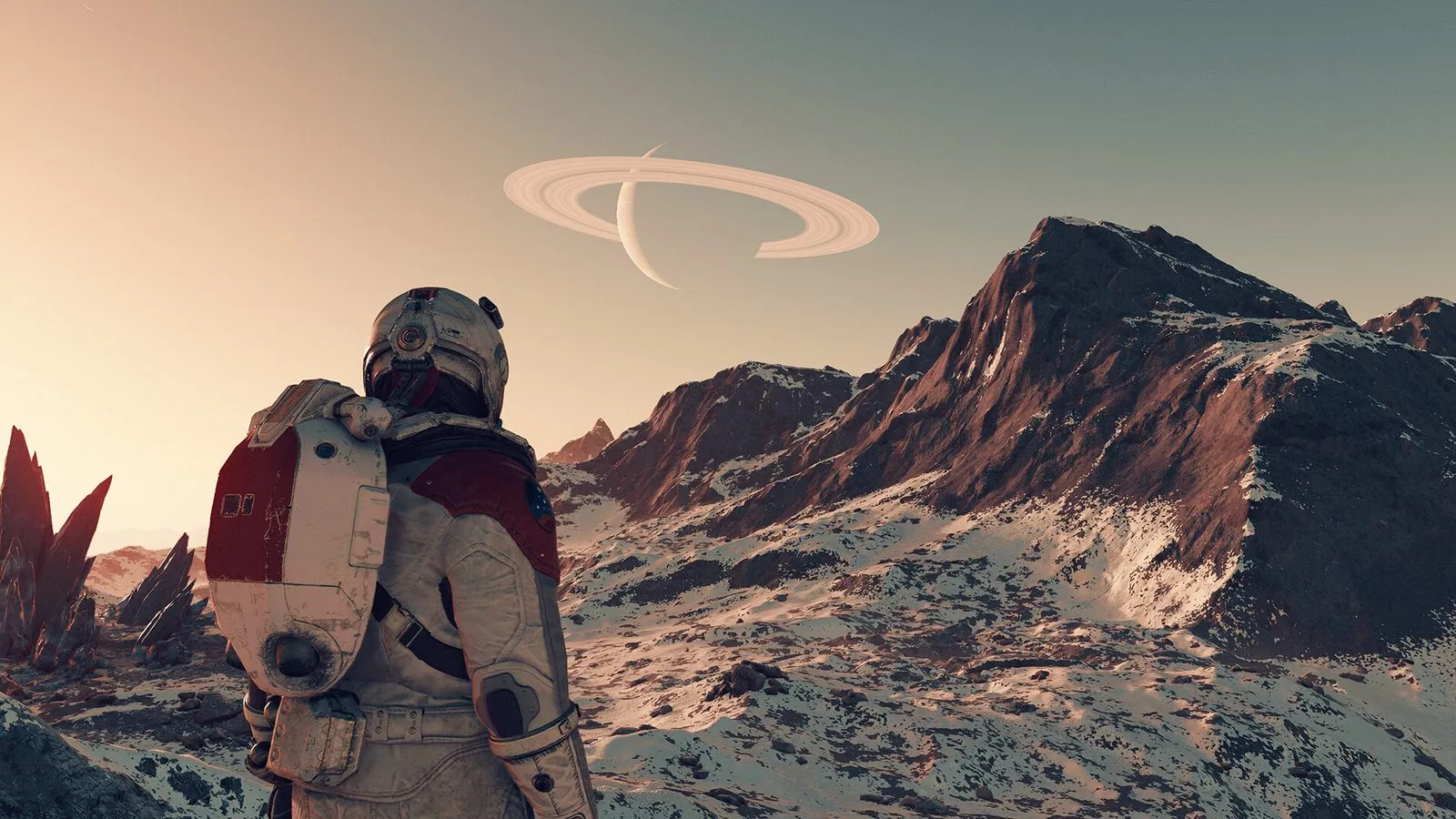 Un explorador con traje espacial en unas montañas nevadas mira un planeta con anillos en el cielo de Starfield