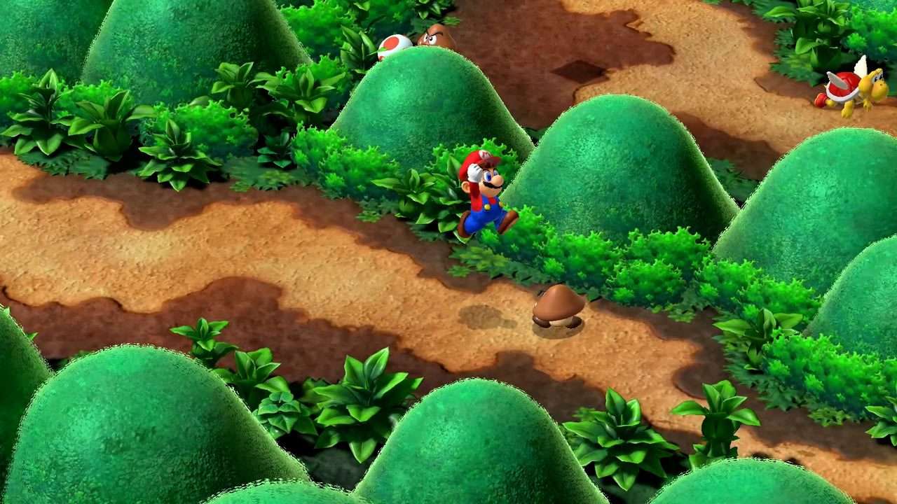Mario salta por un sendero de tierra entre colinas verdes; al fondo hay un Goomba, un Toad y una tortuga alada roja